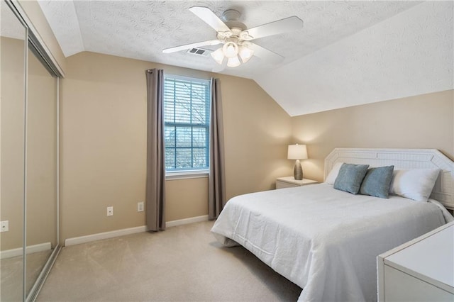 bedroom featuring vaulted ceiling, baseboards, visible vents, and light carpet