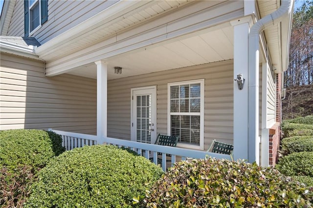 view of exterior entry featuring covered porch