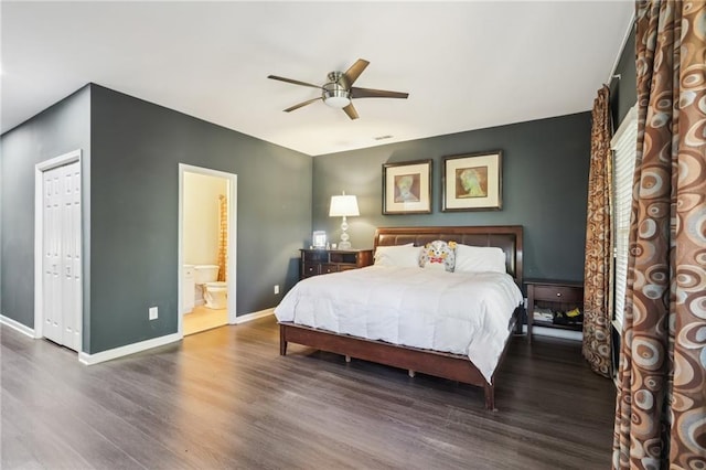 bedroom featuring dark wood-type flooring, a closet, ceiling fan, and ensuite bathroom