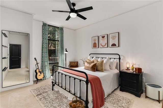 carpeted bedroom with ceiling fan and crown molding