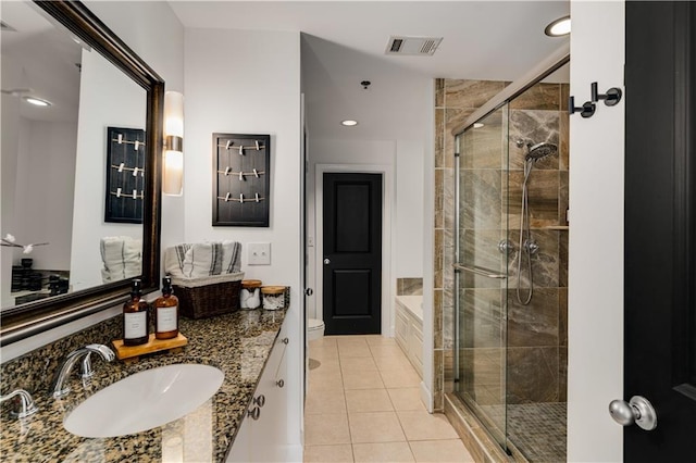 bathroom with vanity, visible vents, a stall shower, tile patterned floors, and toilet