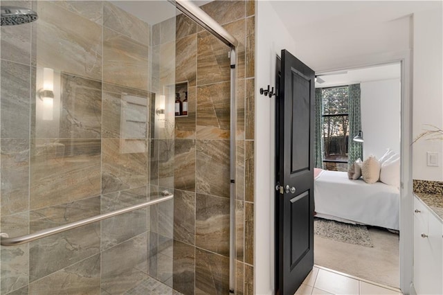 ensuite bathroom featuring connected bathroom, a shower stall, and tile patterned flooring