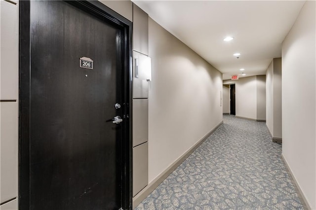 hall featuring recessed lighting, light colored carpet, and baseboards