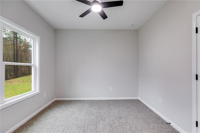 empty room featuring carpet floors, baseboards, and a ceiling fan