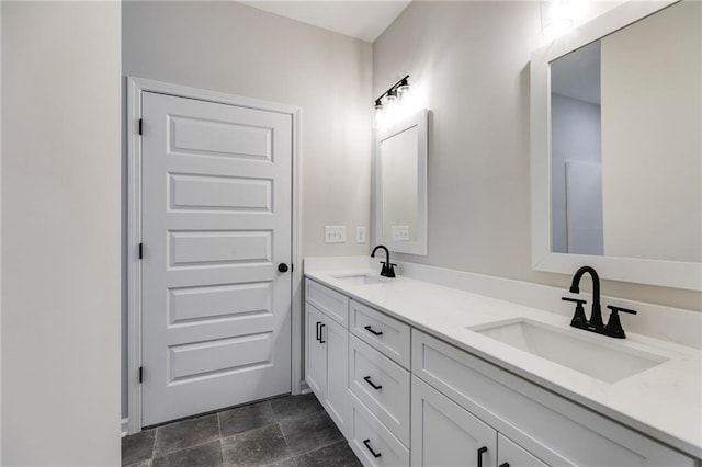 bathroom with double vanity, stone finish flooring, and a sink