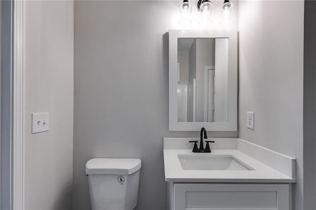 bathroom with toilet and vanity