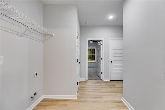 washroom with light wood finished floors, recessed lighting, electric dryer hookup, laundry area, and baseboards