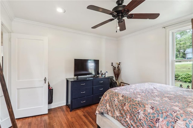 bedroom with dark wood finished floors, crown molding, baseboards, and ceiling fan