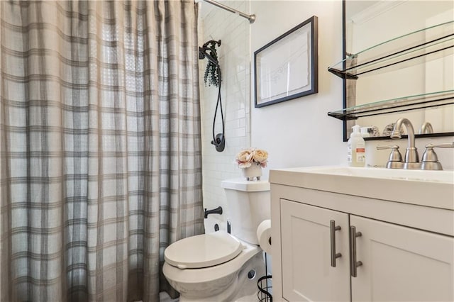 bathroom featuring toilet, curtained shower, and vanity