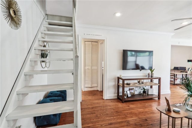 stairway with recessed lighting, crown molding, baseboards, and wood finished floors