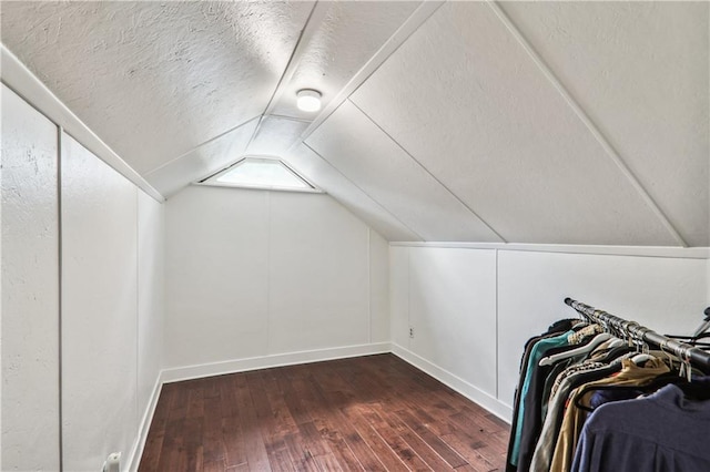 bonus room with vaulted ceiling, a textured ceiling, and hardwood / wood-style floors