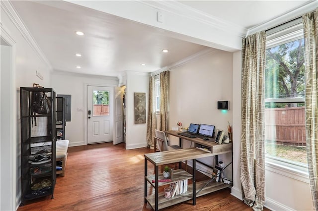 office area featuring baseboards, wood finished floors, and crown molding