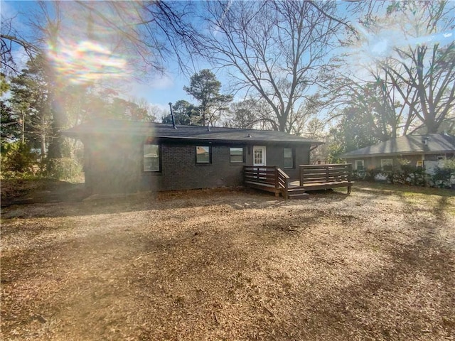 back of property featuring a deck