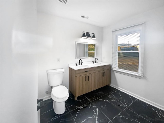 bathroom featuring vanity and toilet