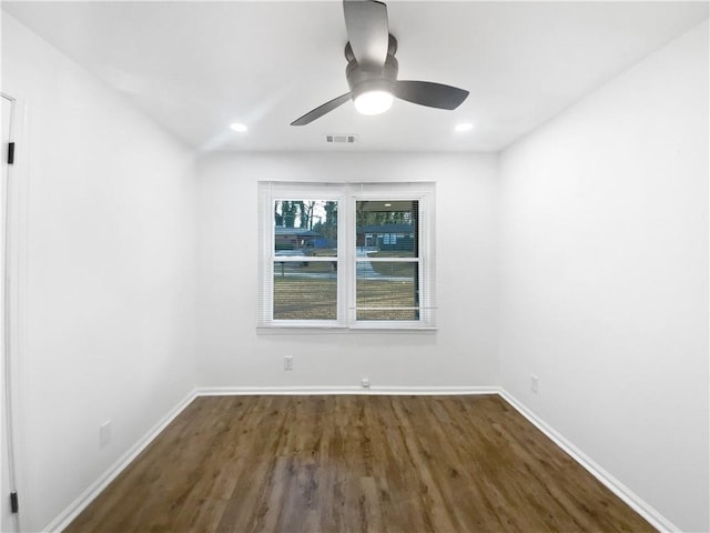 empty room with dark hardwood / wood-style floors and ceiling fan