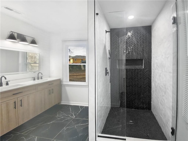 bathroom with vanity and a shower with shower door