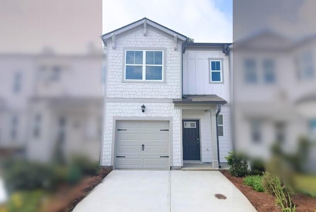 view of front of home featuring an attached garage, board and batten siding, and concrete driveway