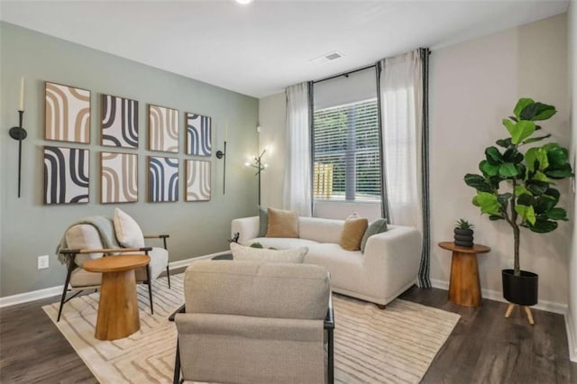 sitting room featuring dark wood-style floors, baseboards, and visible vents