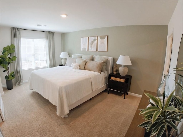 bedroom with light carpet, baseboards, and visible vents