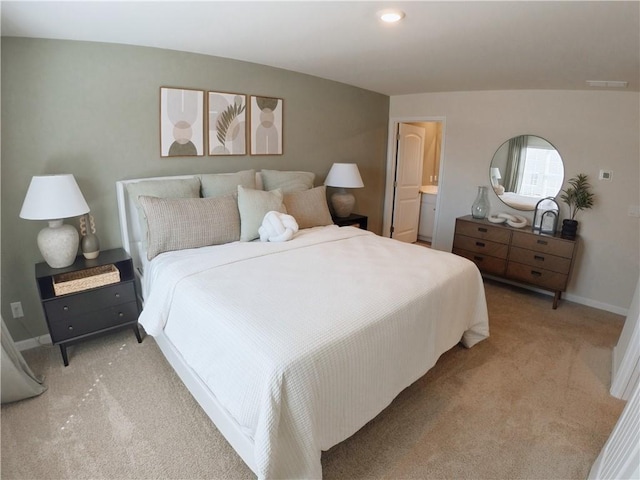 bedroom with light carpet and baseboards