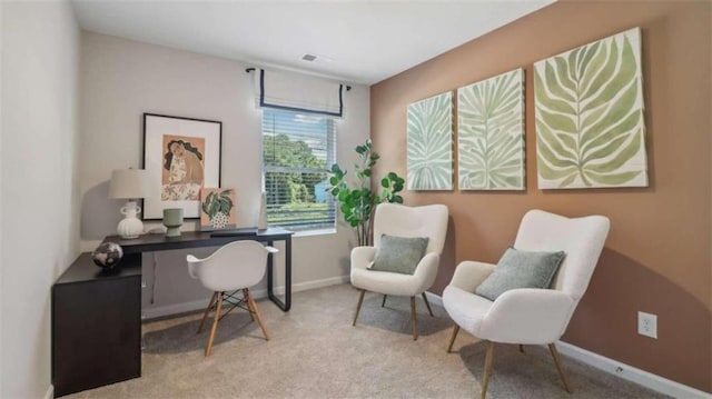 office area featuring light carpet, visible vents, and baseboards