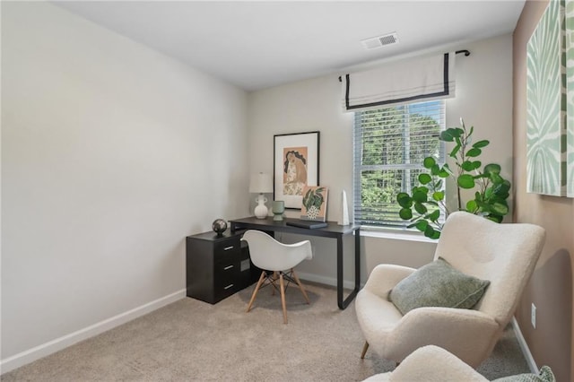 office space with visible vents, baseboards, and light colored carpet