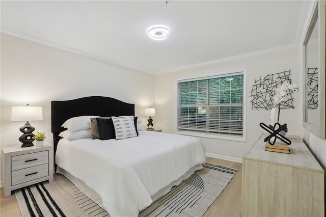 bedroom featuring crown molding and light wood-type flooring