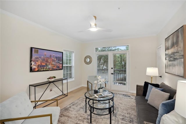 living room with ceiling fan, crown molding, french doors, and light hardwood / wood-style flooring