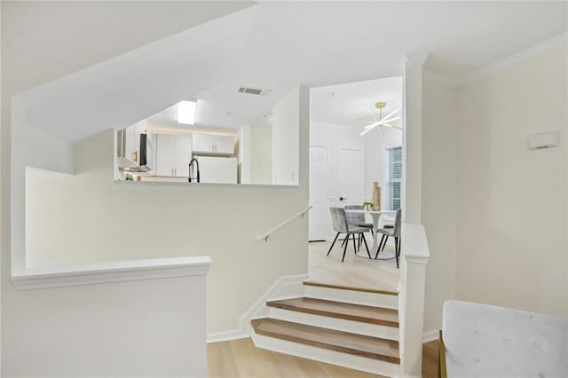 4254 River Green Dr NW Unit 616, Atlanta, GA 30327 - staircase with wood finished floors, baseboards, ornamental molding, and visible vents