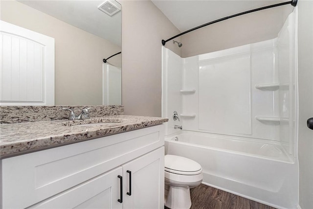 bathroom with shower / bath combination, visible vents, toilet, wood finished floors, and vanity