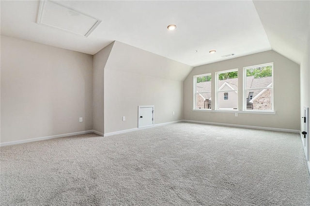 bonus room with vaulted ceiling, carpet, attic access, and baseboards