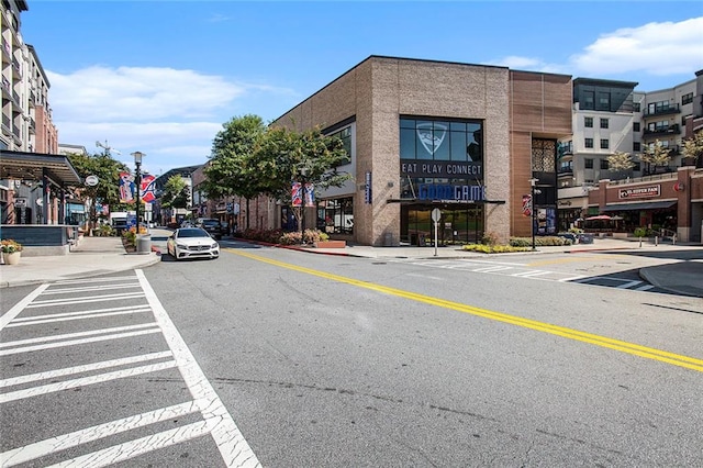 view of road featuring street lighting, curbs, and sidewalks