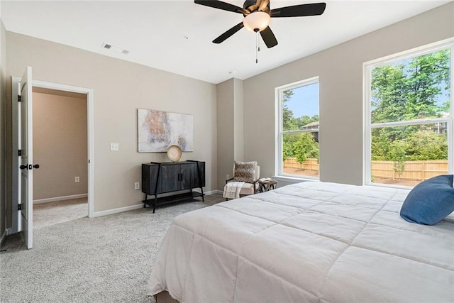 bedroom with ceiling fan, carpet floors, visible vents, and baseboards