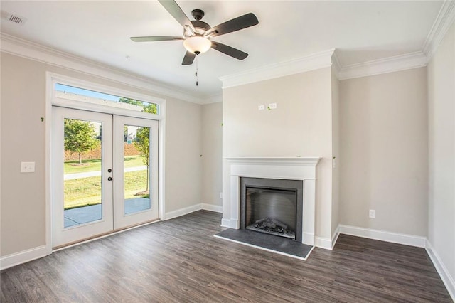 unfurnished living room with visible vents, a fireplace with raised hearth, dark wood-type flooring, crown molding, and french doors