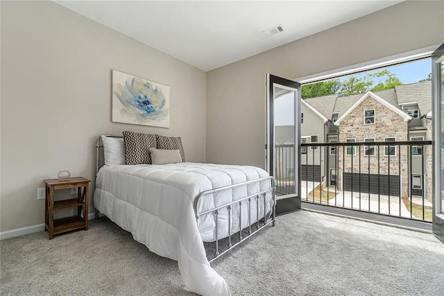 bedroom with access to outside, carpet flooring, visible vents, and baseboards