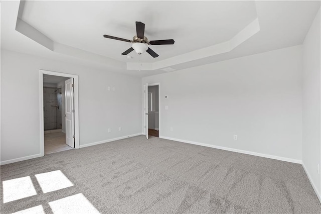 46 Cooper Dr, Mansfield, GA 30055 - unfurnished bedroom with a tray ceiling, carpet, ensuite bath, and a ceiling fan