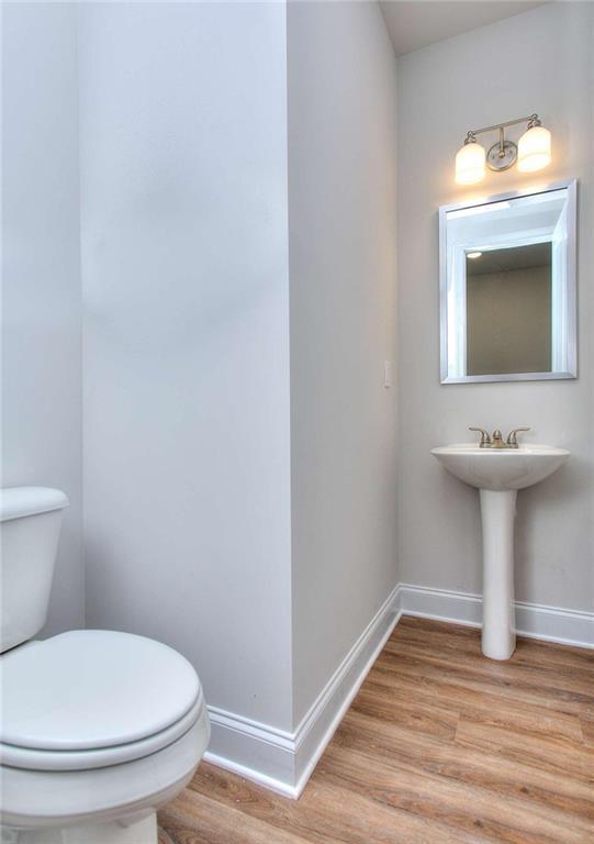 46 Cooper Dr, Mansfield, GA 30055 - bathroom with wood finished floors and toilet