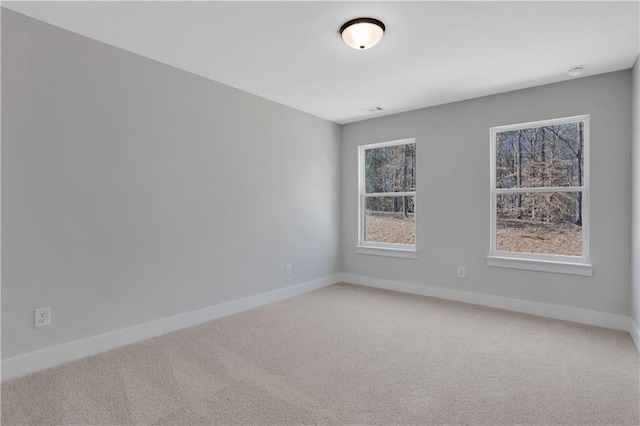 carpeted spare room with baseboards