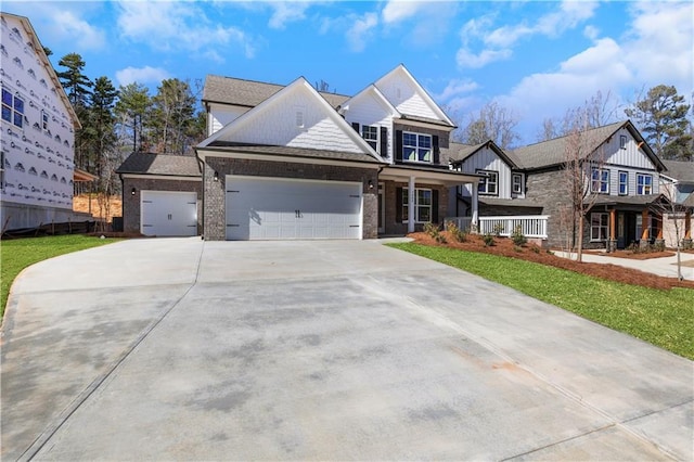 view of front of property featuring covered porch, driveway, and an attached garage