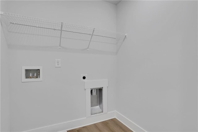 washroom featuring washer hookup, electric dryer hookup, wood finished floors, laundry area, and baseboards