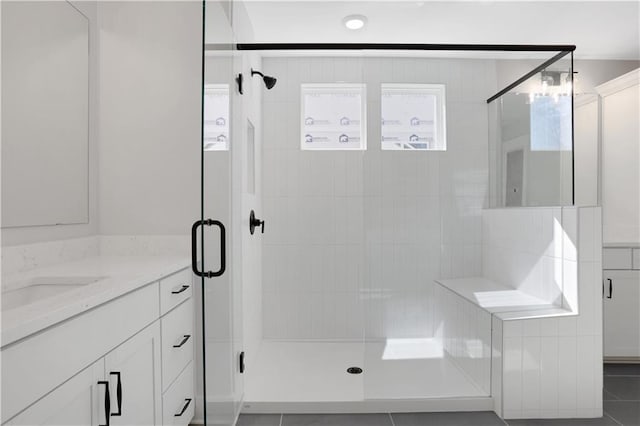 bathroom with a shower stall and vanity