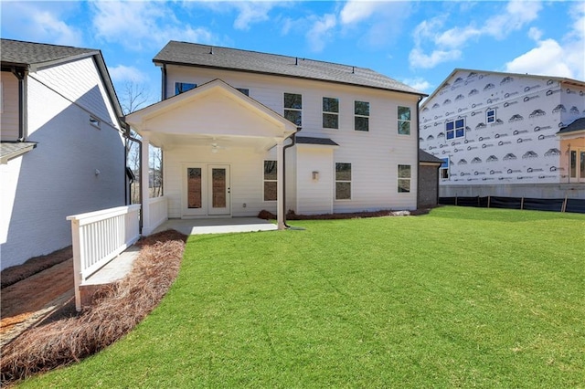 rear view of house featuring french doors, a yard, a patio, ceiling fan, and fence