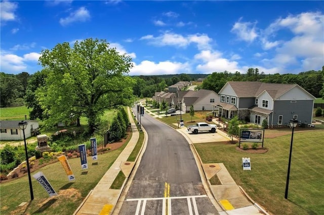 view of road featuring street lighting, a residential view, curbs, and sidewalks