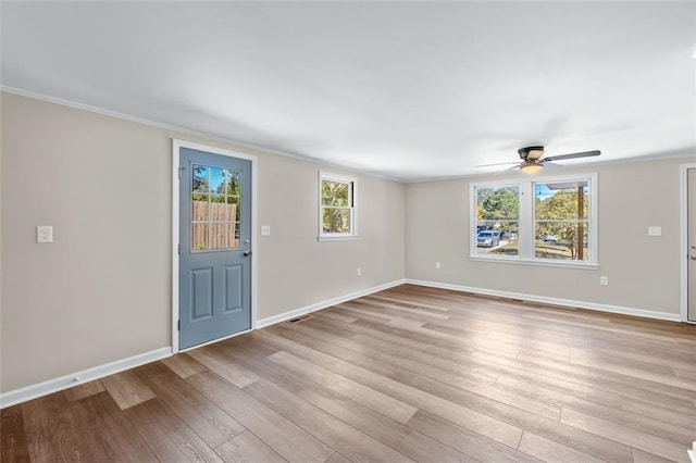 610 Ash Ln, Monroe, GA 30655 - unfurnished living room with a ceiling fan, visible vents, baseboards, ornamental molding, and wood finished floors