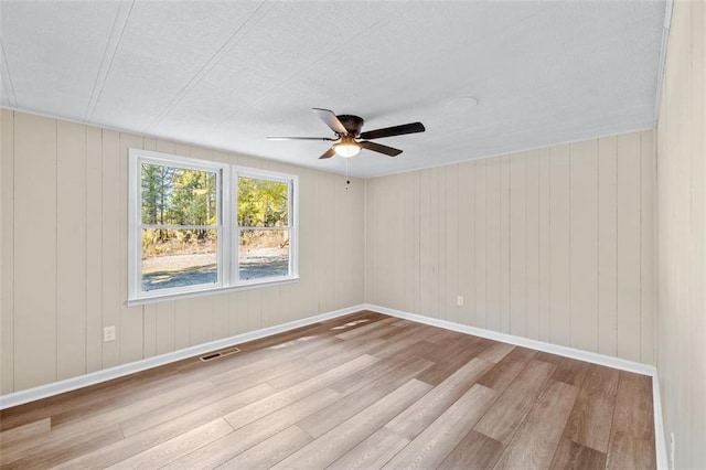610 Ash Ln, Monroe, GA 30655 - empty room with wood finished floors, ceiling fan, visible vents, and baseboards