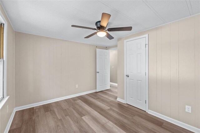 610 Ash Ln, Monroe, GA 30655 - unfurnished bedroom featuring wood finished floors, ceiling fan, and baseboards