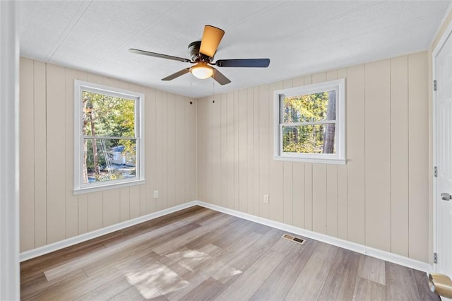 610 Ash Ln, Monroe, GA 30655 - empty room featuring wood finished floors, ceiling fan, and visible vents