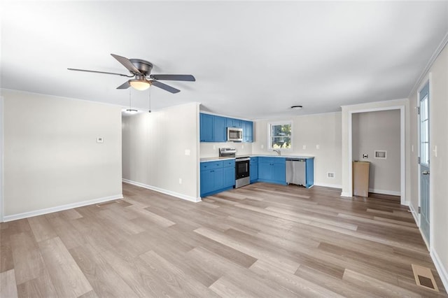 kitchen with light hardwood / wood-style flooring, crown molding, blue cabinetry, appliances with stainless steel finishes, and ceiling fan