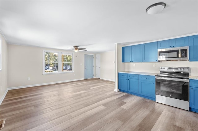 610 Ash Ln, Monroe, GA 30655 - kitchen with ceiling fan, blue cabinetry, stainless steel appliances, and light wood-style flooring