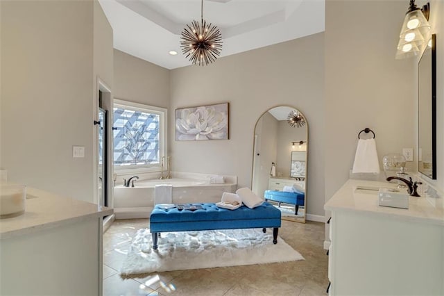 bathroom featuring a garden tub, tile patterned flooring, a notable chandelier, and vanity